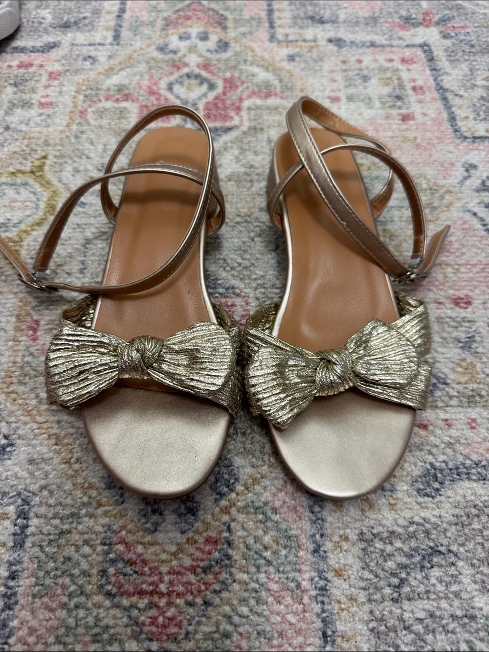 Girls gold ankle wrap sandals with bow.